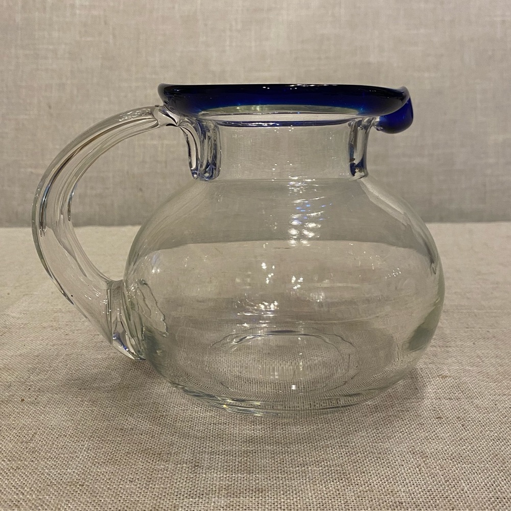 Glass blue rim jug. Blown glass pitcher by artisan blowers from Tonala, Jalisco.